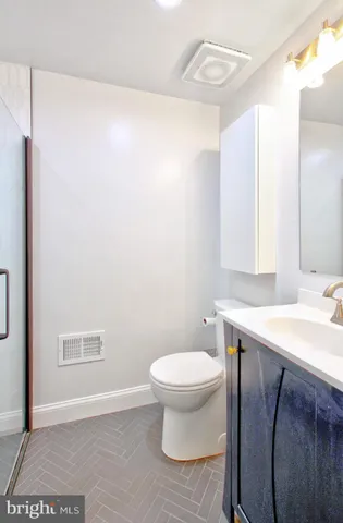 a bathroom with a sink toilet and vanity