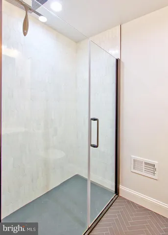 a bathroom with a glass shower door