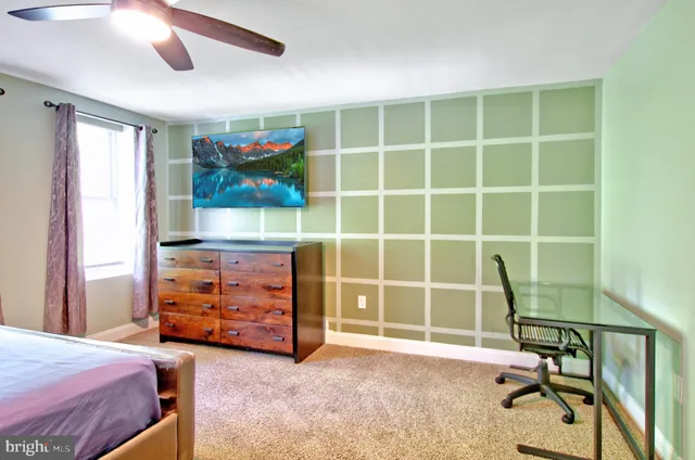 a view of a bedroom with workspace and a window