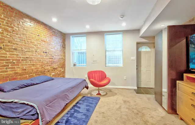 a bedroom with a bed and a television