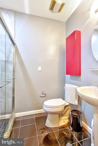 a bathroom with a toilet a sink and a mirror