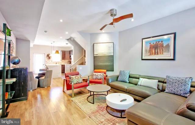 a living room with furniture and a book shelf