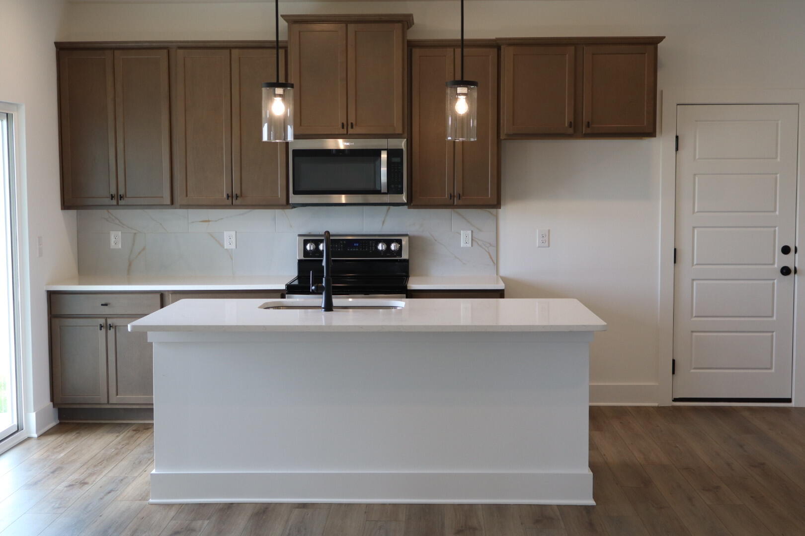 350 Bluebeech Street Freeport, FL 32439 - Photo 3 of 42 a kitchen with stainless steel appliances a stove a microwave a sink and cabinets