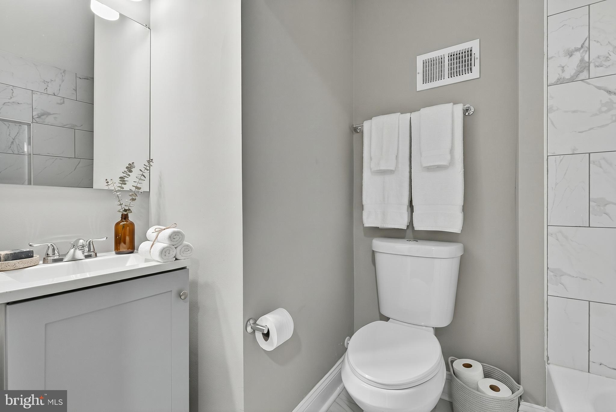 320 South Pulaski Street Baltimore, MD 21223 - Photo 12 of 46 a bathroom with a toilet sink and mirror