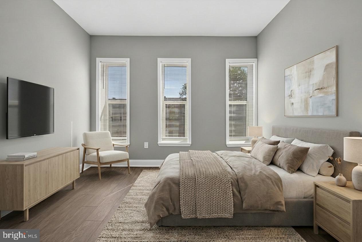 320 South Pulaski Street Baltimore, MD 21223 - Photo 14 of 46 a spacious bedroom with a bed and a flat screen tv