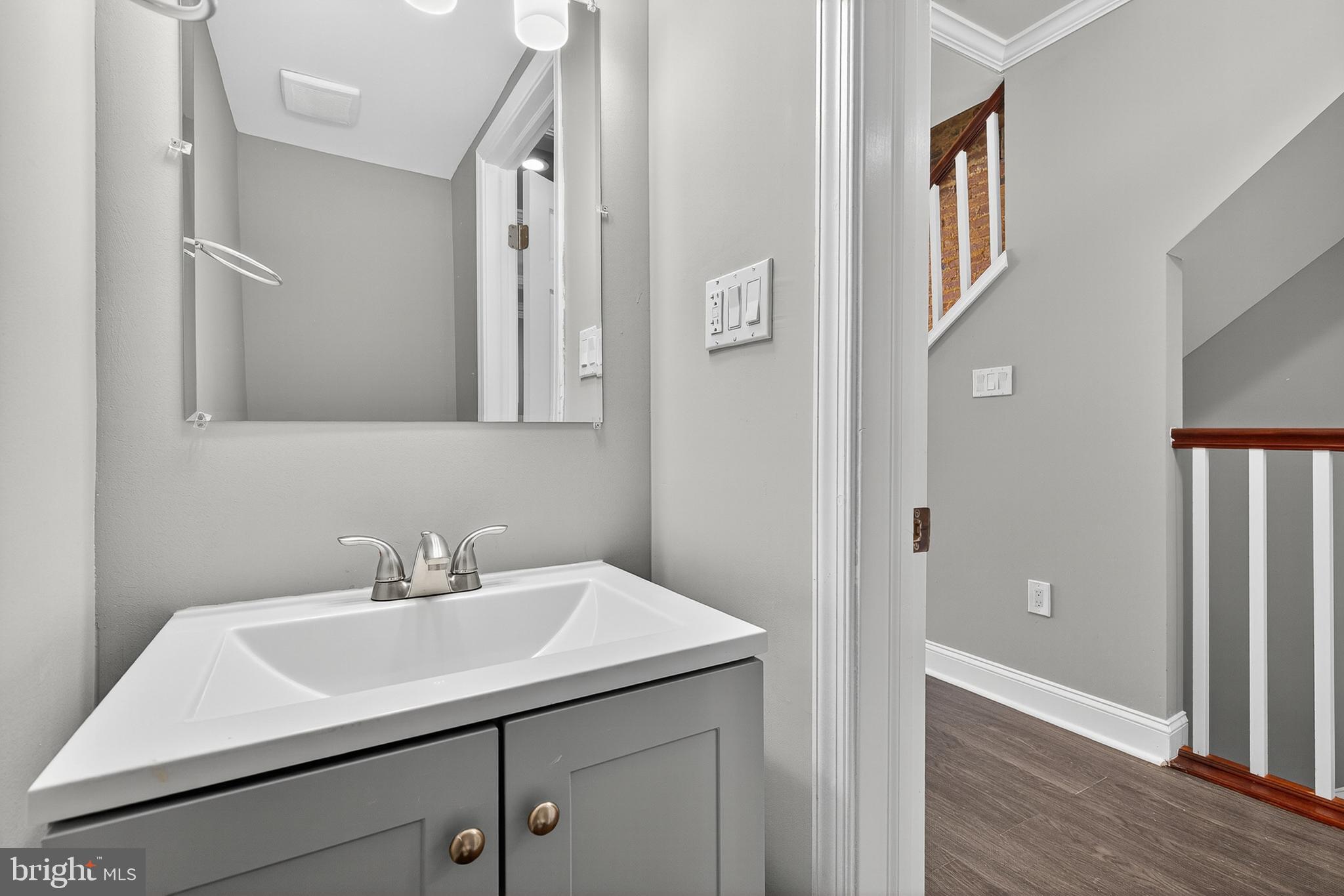 320 South Pulaski Street Baltimore, MD 21223 - Photo 20 of 46 a bathroom with a sink and a mirror