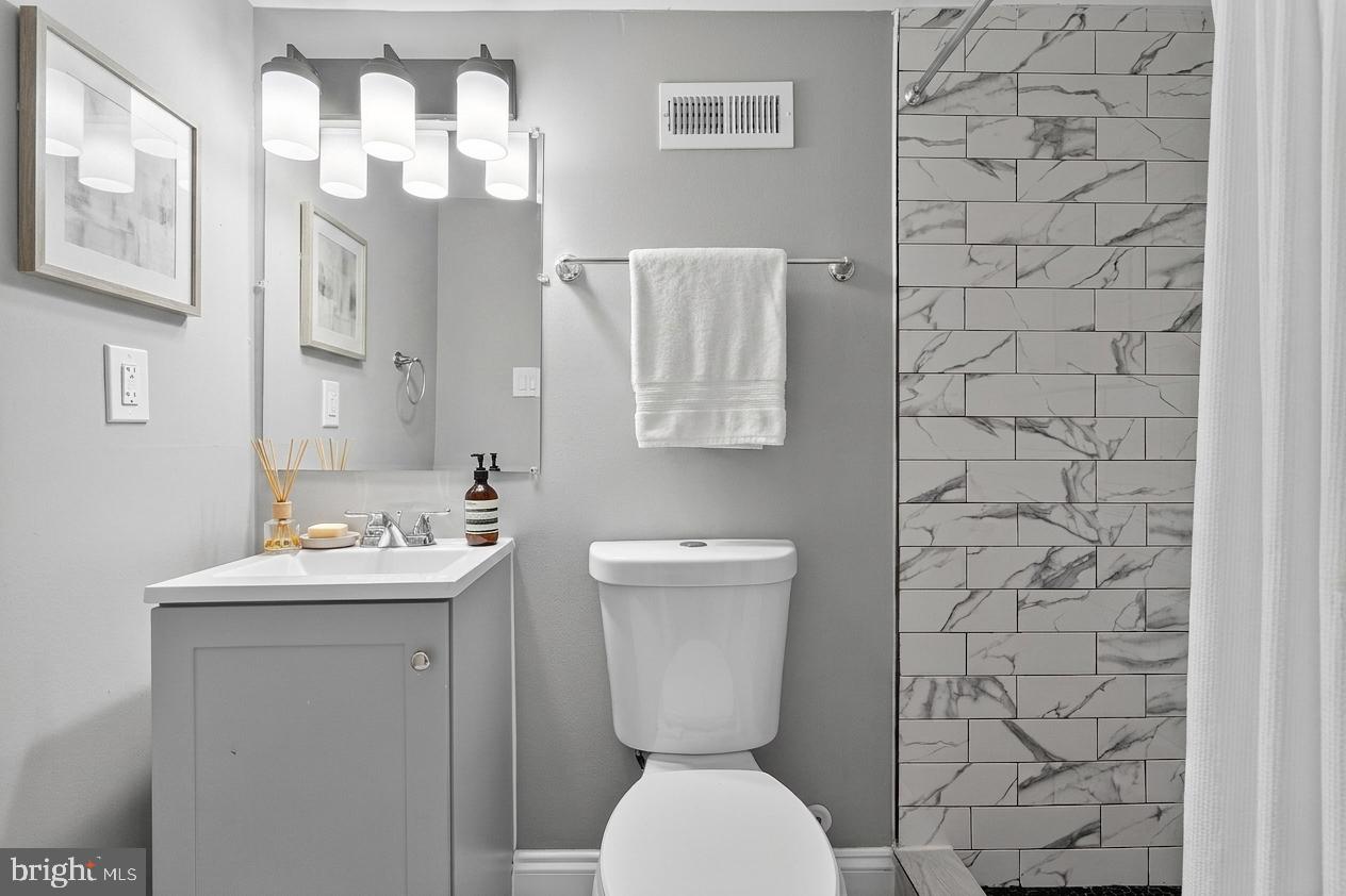 320 South Pulaski Street Baltimore, MD 21223 - Photo 23 of 46 a bathroom with a toilet sink and mirror