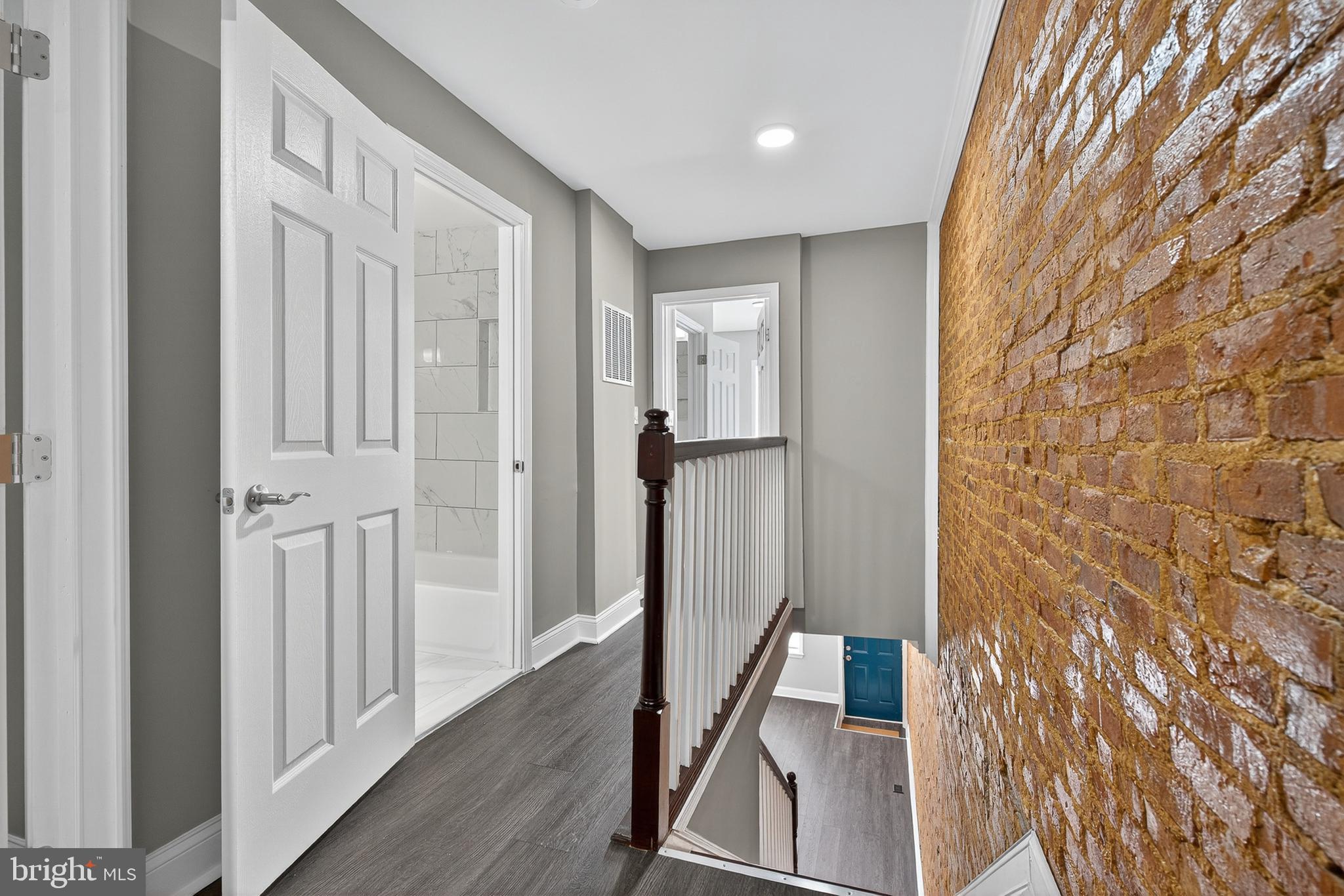320 South Pulaski Street Baltimore, MD 21223 - Photo 24 of 46 a view of a hallway with wooden floor and staircase