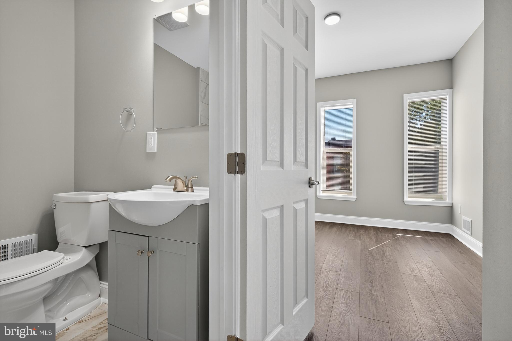 320 South Pulaski Street Baltimore, MD 21223 - Photo 25 of 46 a bathroom with a sink toilet and vanity