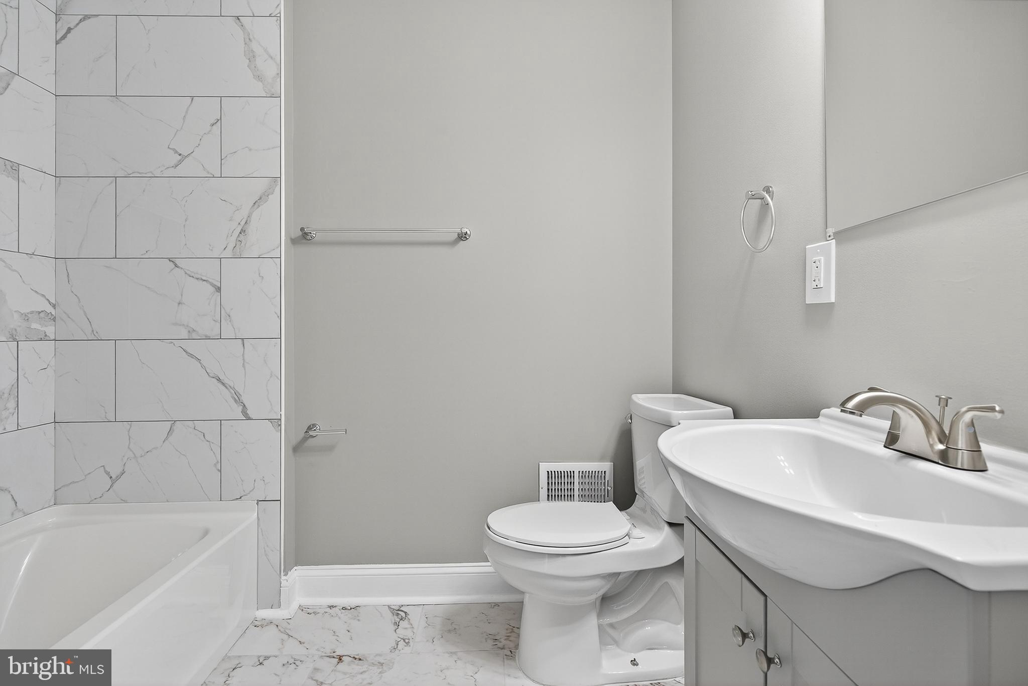 320 South Pulaski Street Baltimore, MD 21223 - Photo 26 of 46 a white toilet sitting next to a bath tub