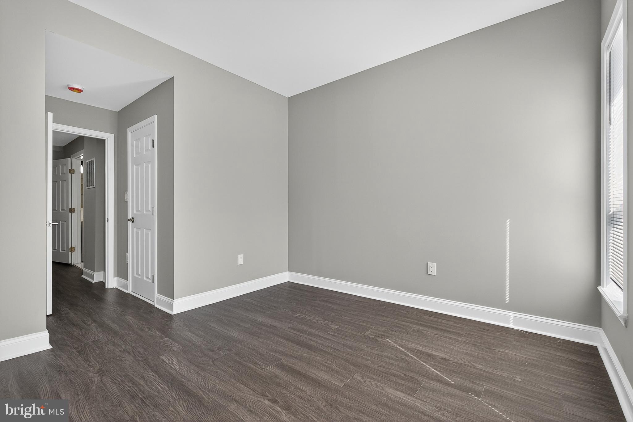 320 South Pulaski Street Baltimore, MD 21223 - Photo 28 of 46 a view of an empty room with wooden floor