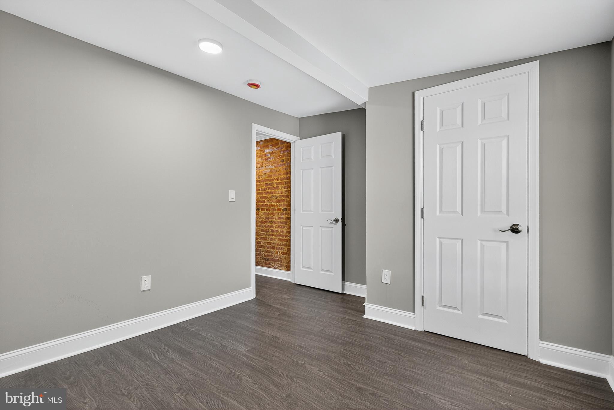 320 South Pulaski Street Baltimore, MD 21223 - Photo 29 of 46 a view of an empty room with wooden floor