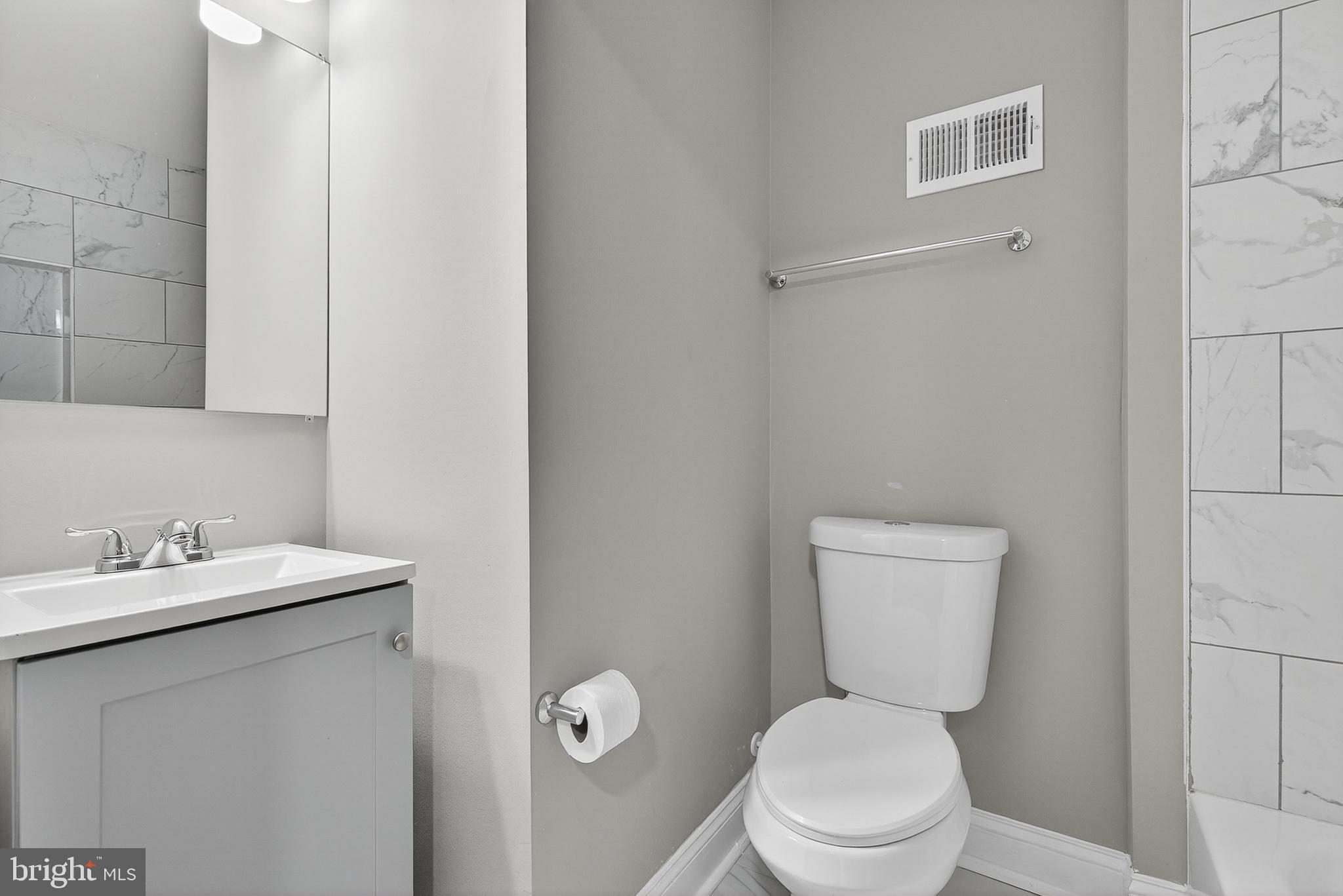 320 South Pulaski Street Baltimore, MD 21223 - Photo 31 of 46 a white toilet sitting next to a bathroom sink