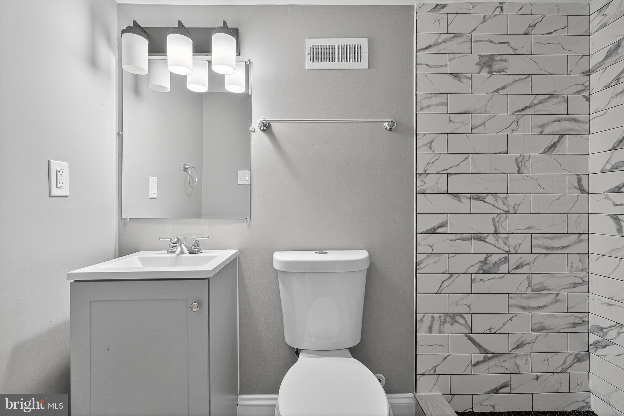 320 South Pulaski Street Baltimore, MD 21223 - Photo 32 of 46 a bathroom with a toilet sink and mirror