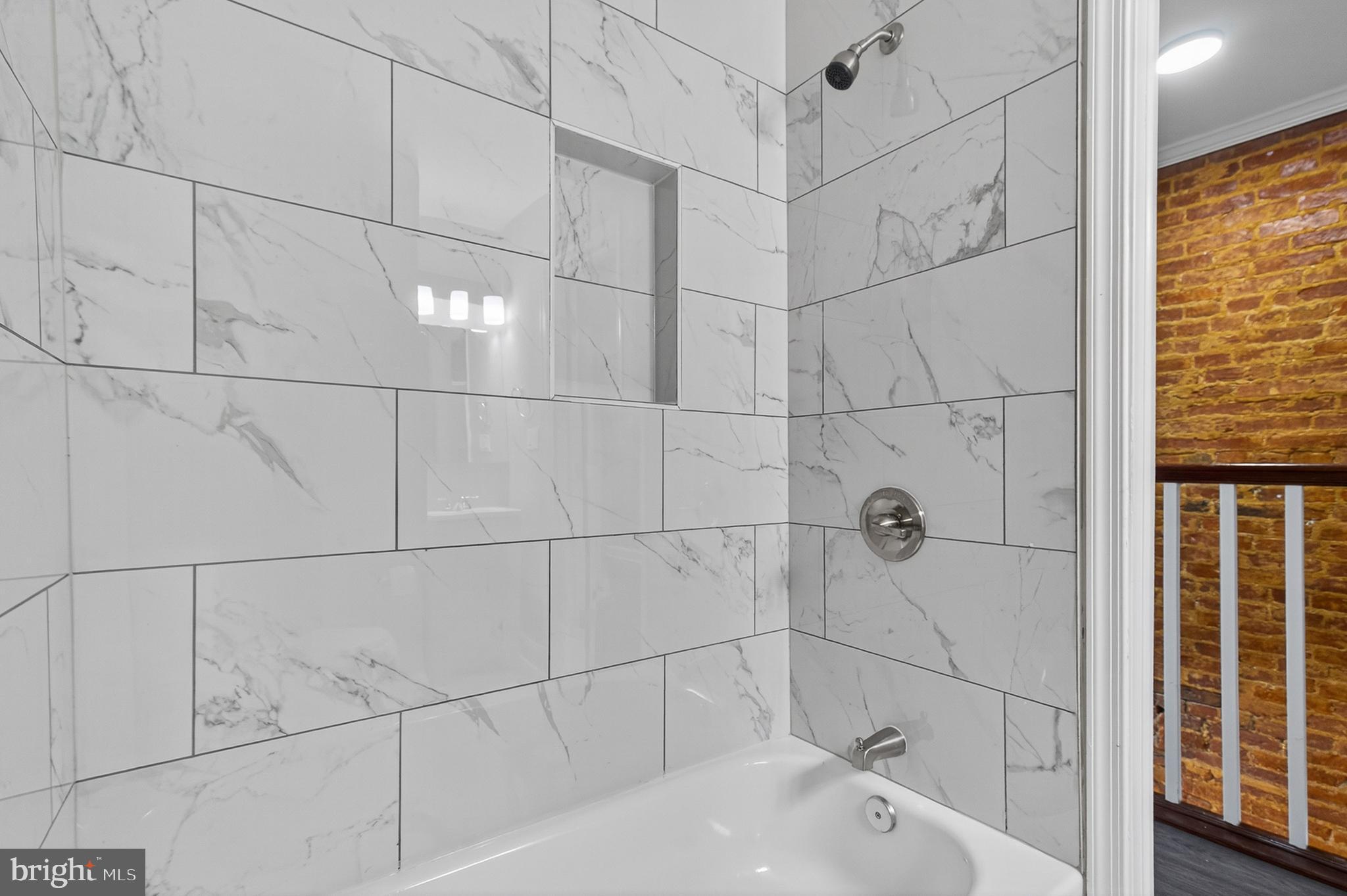 320 South Pulaski Street Baltimore, MD 21223 - Photo 33 of 46 a bathroom with a bathtub and shower