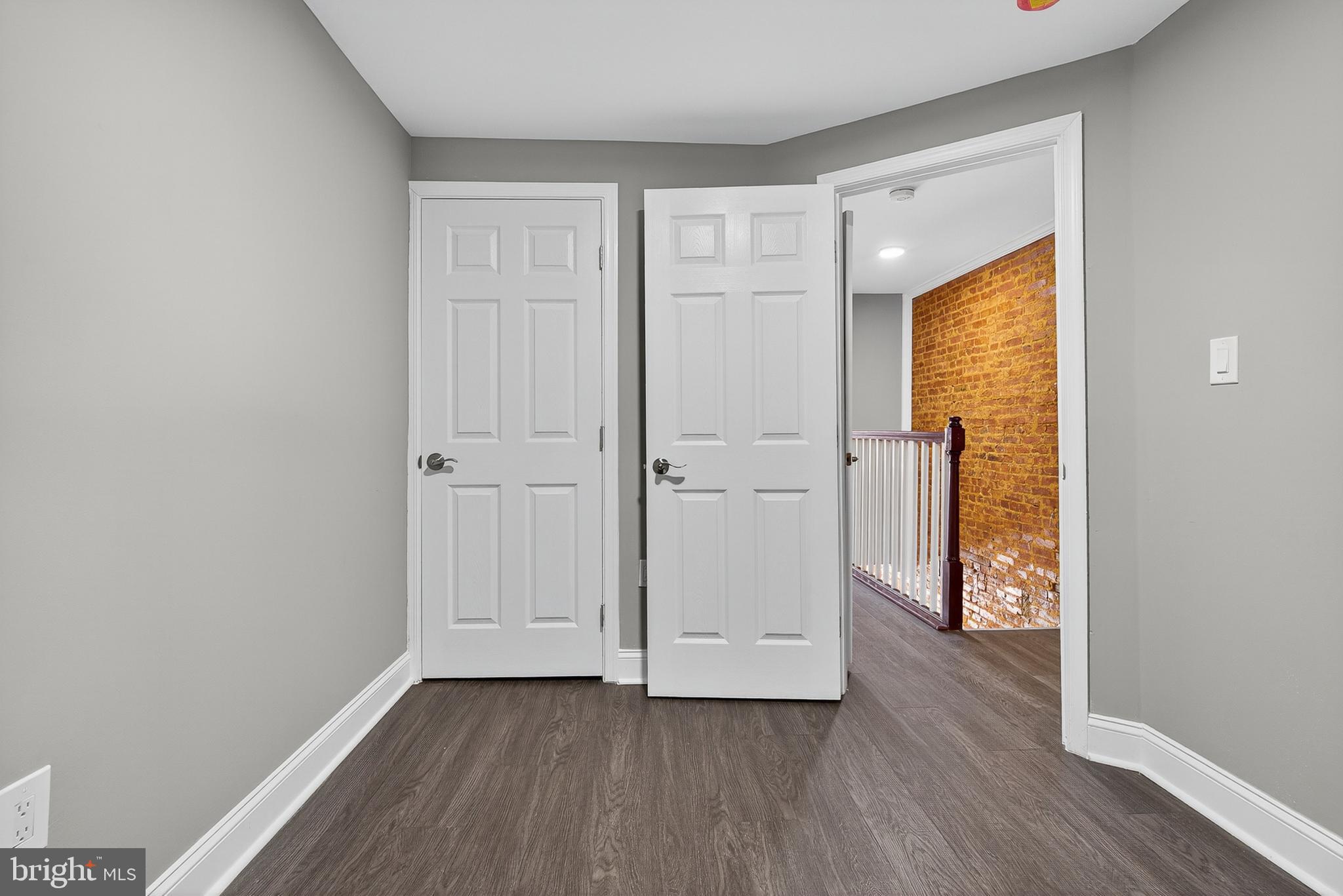 320 South Pulaski Street Baltimore, MD 21223 - Photo 35 of 46 a view of an empty room with wooden floor and a window