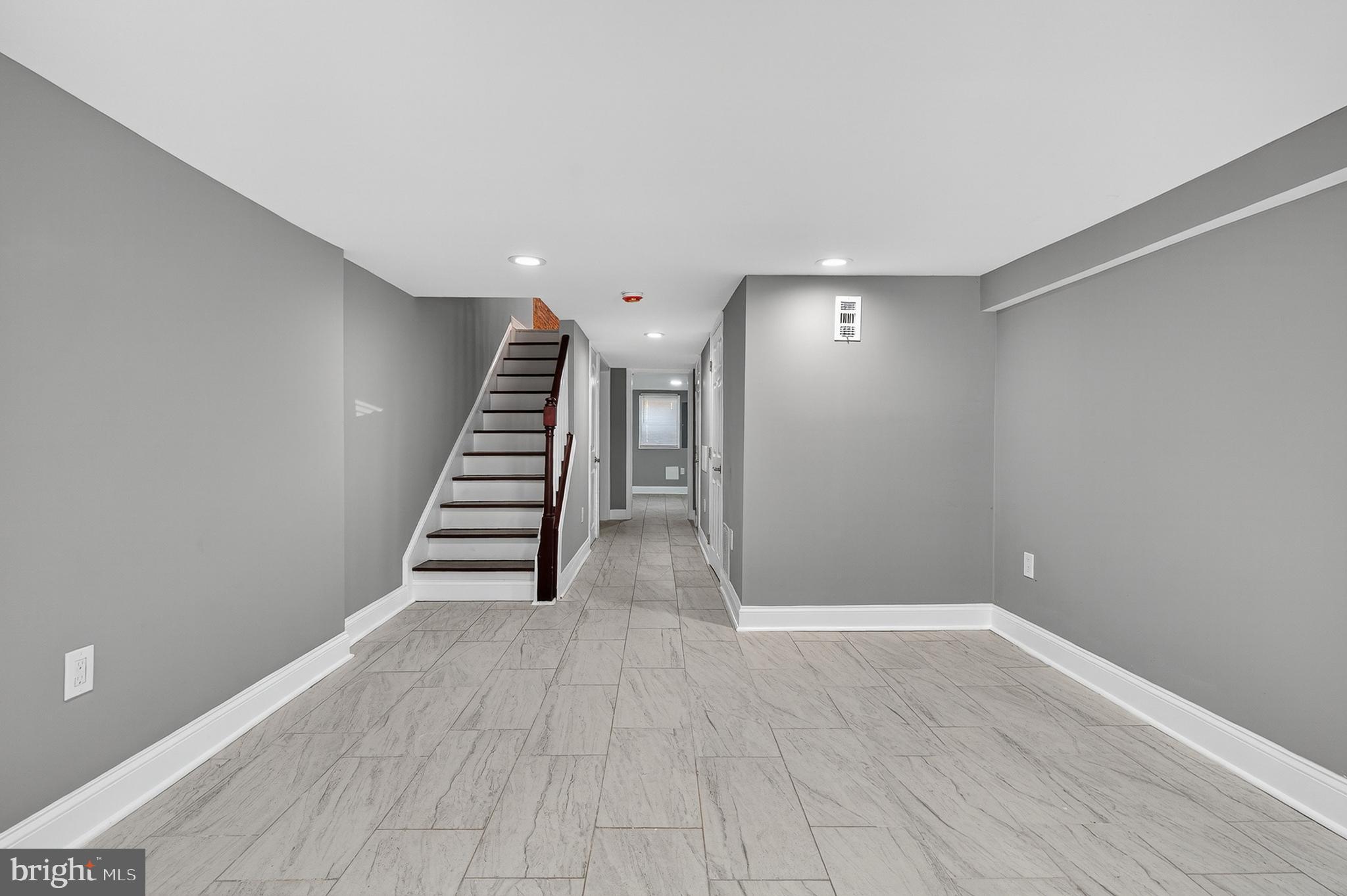 320 South Pulaski Street Baltimore, MD 21223 - Photo 37 of 46 a view of a room with stairs and wooden floor