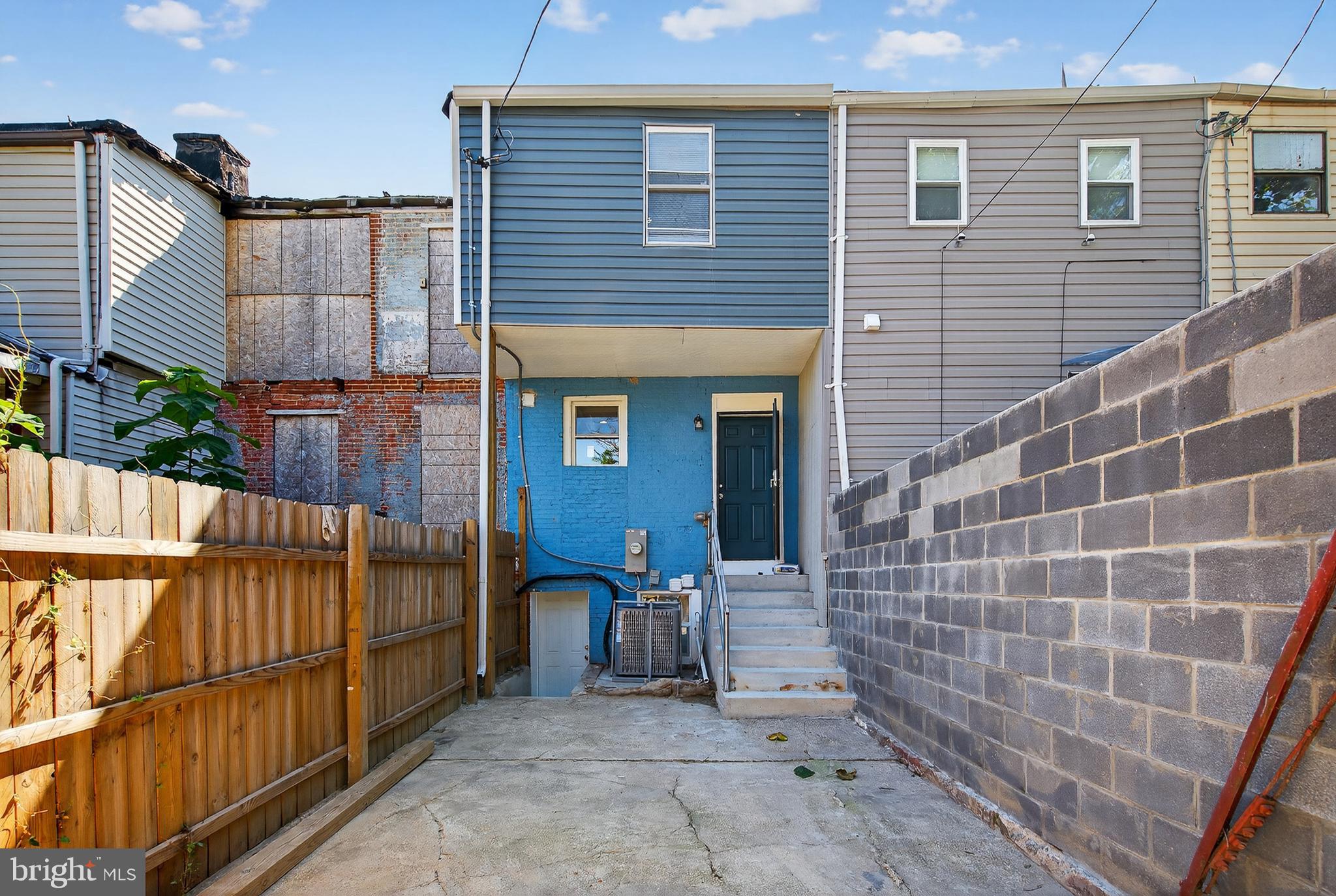 320 South Pulaski Street Baltimore, MD 21223 - Photo 42 of 46 a view of a brick house with wooden fence
