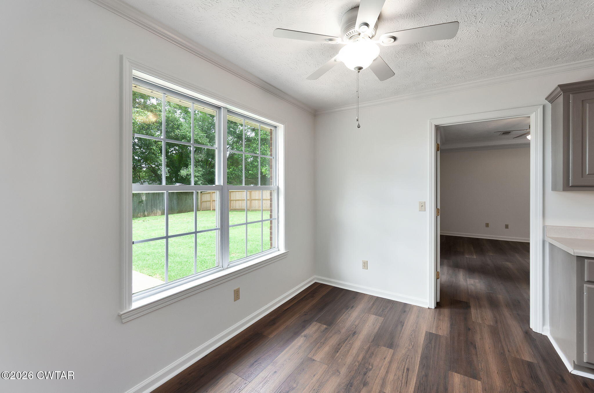 96 Sundown Drive Jackson, TN 38305 - Photo 13 of 28 a view of an empty room with wooden floor and a window