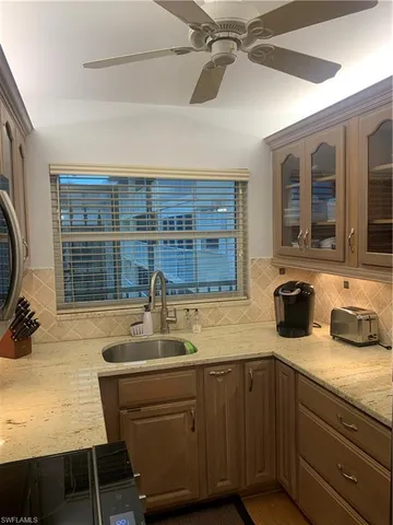 a kitchen with a sink a stove and a wooden floor