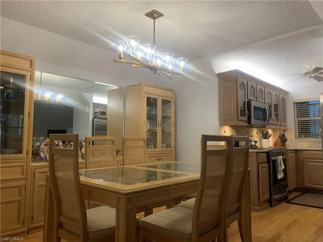 a dining room with furniture and chandelier