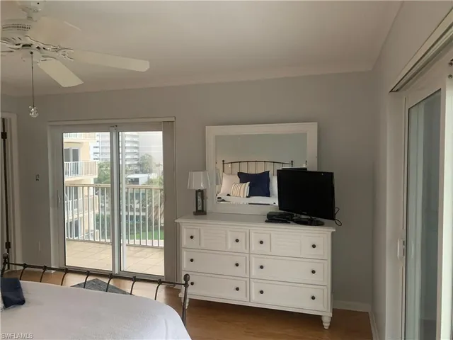 a bedroom with furniture and flat screen tv