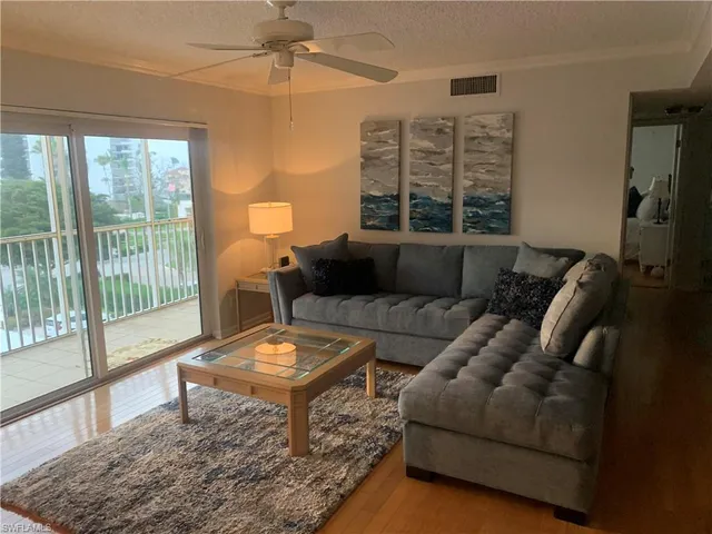 a living room with furniture and a floor to ceiling window