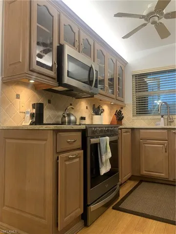 a kitchen with stainless steel appliances granite countertop a stove and a microwave
