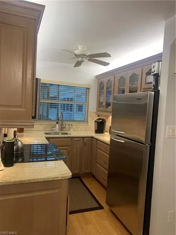 a kitchen with stainless steel appliances a refrigerator sink and cabinets
