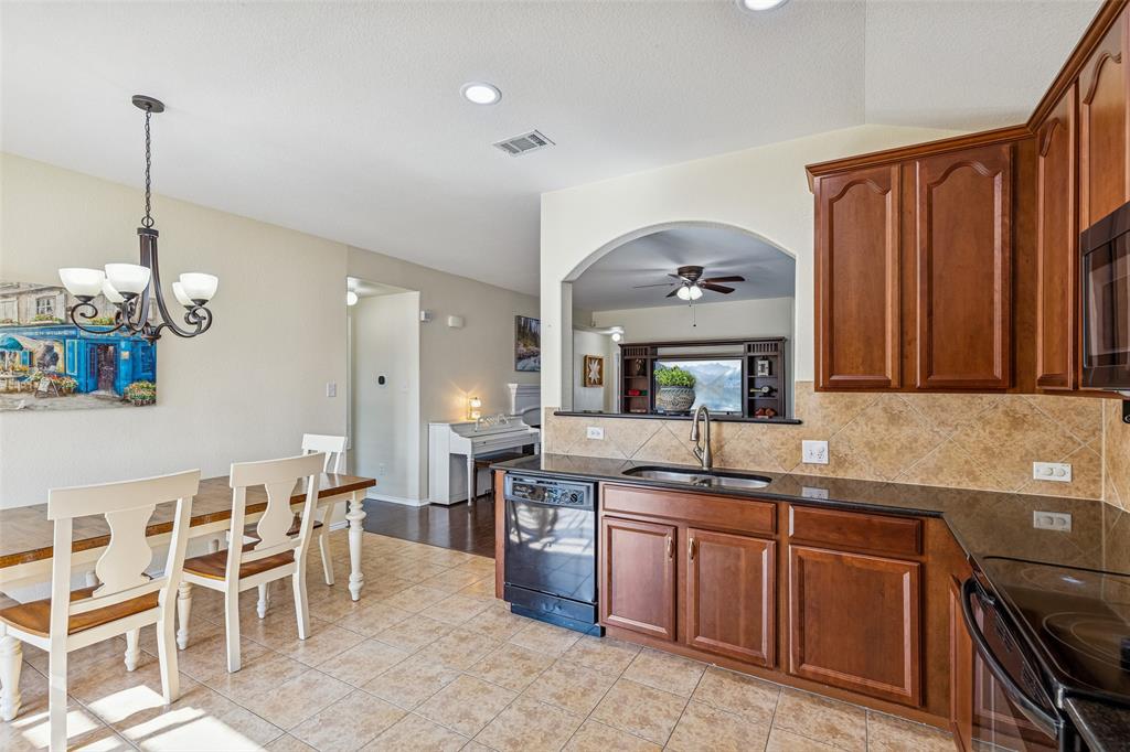 506 Austin Lane Lavon, TX 75166 - Photo 13 of 24 a kitchen with granite countertop a sink stove and cabinets