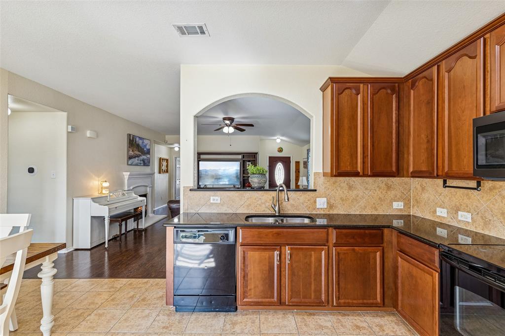 506 Austin Lane Lavon, TX 75166 - Photo 14 of 24 a kitchen with kitchen island granite countertop a sink counter top space and cabinets