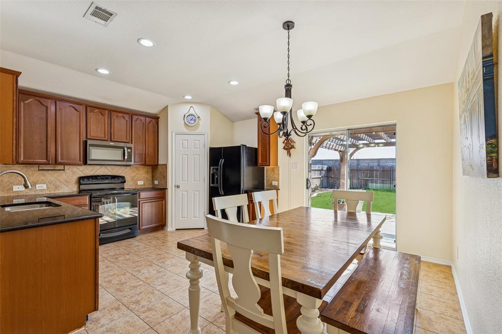 506 Austin Lane Lavon, TX 75166 - Photo 15 of 24 a view of a dining room with furniture a kitchen and chandelier