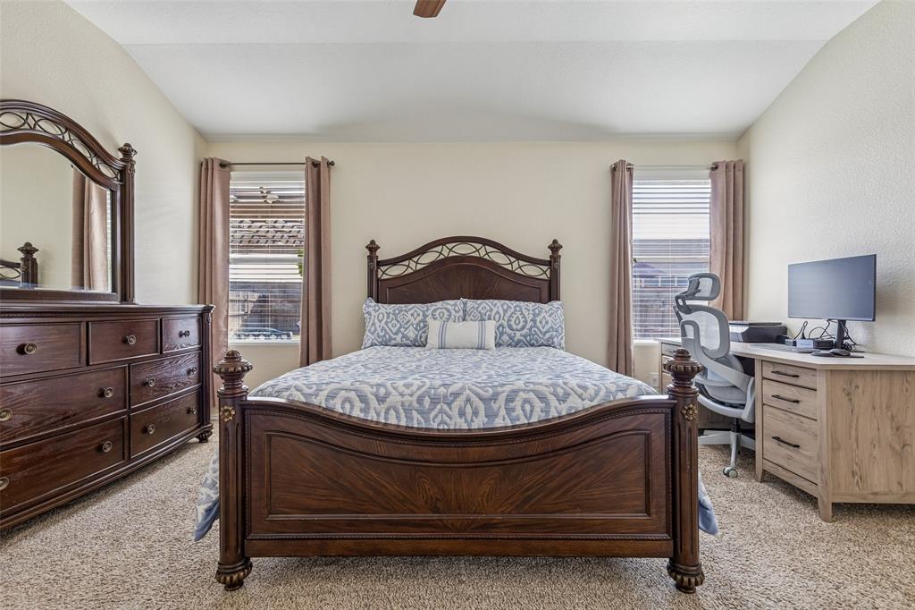 506 Austin Lane Lavon, TX 75166 - Photo 16 of 24 a bed sitting in a bedroom next to a window with dresser