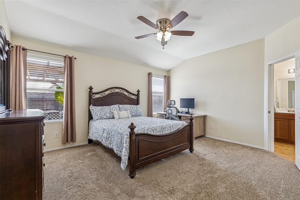 506 Austin Lane Lavon, TX 75166 - Photo 17 of 24 a spacious bedroom with a bed and a chandelier