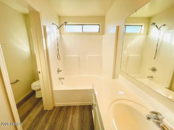 a bathroom with a tub shower and a sink