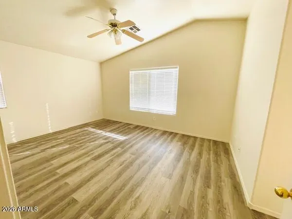 a view of a big room with windows and chandelier fan