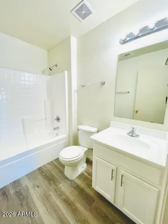 a bathroom with a sink a toilet and a large mirror