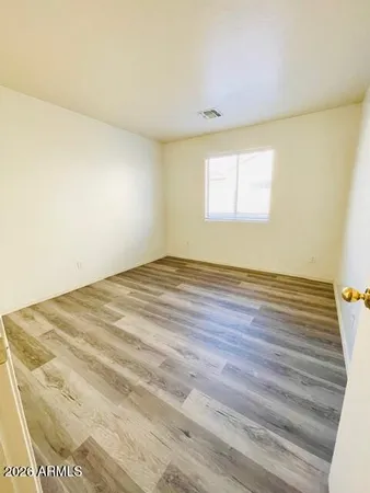 a view of a room with wooden floor and white walls