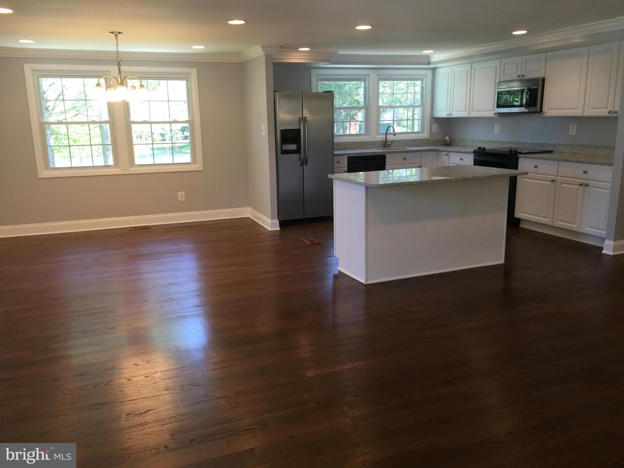 5146 Downwest Ride Columbia, MD 21044 - Photo 26 of 26 an open kitchen with kitchen island and stainless steel appliances