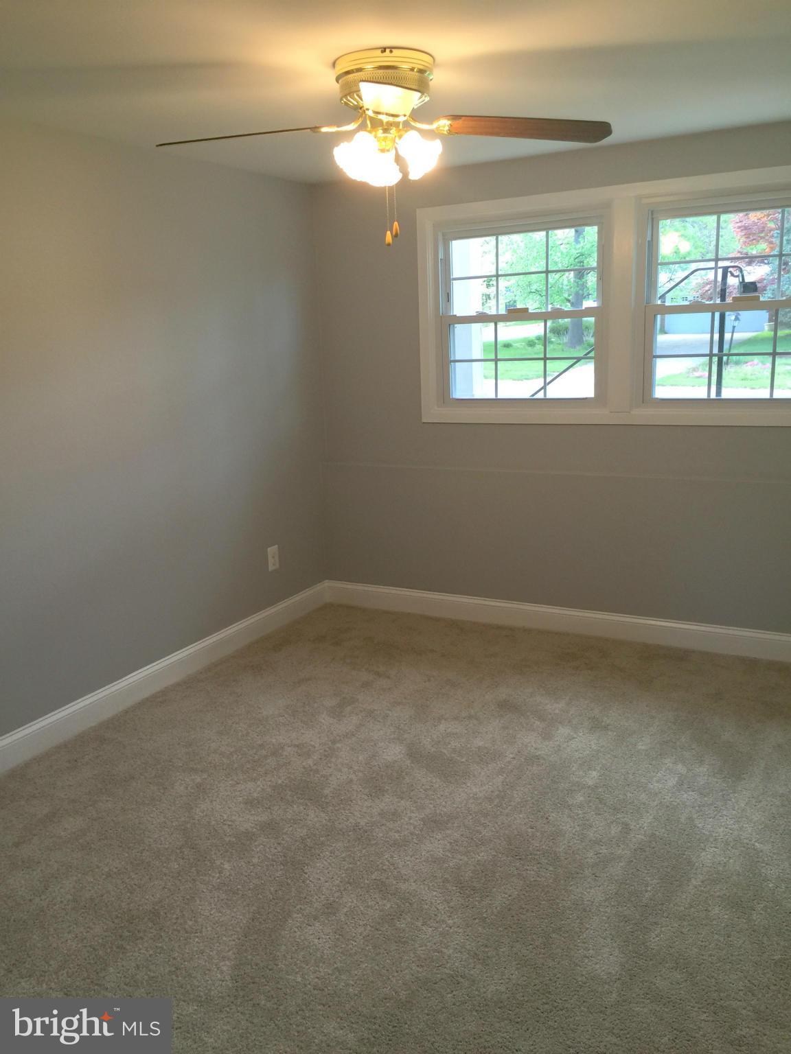 5146 Downwest Ride Columbia, MD 21044 - Photo 16 of 26 en empty room with windows and chandelier fan