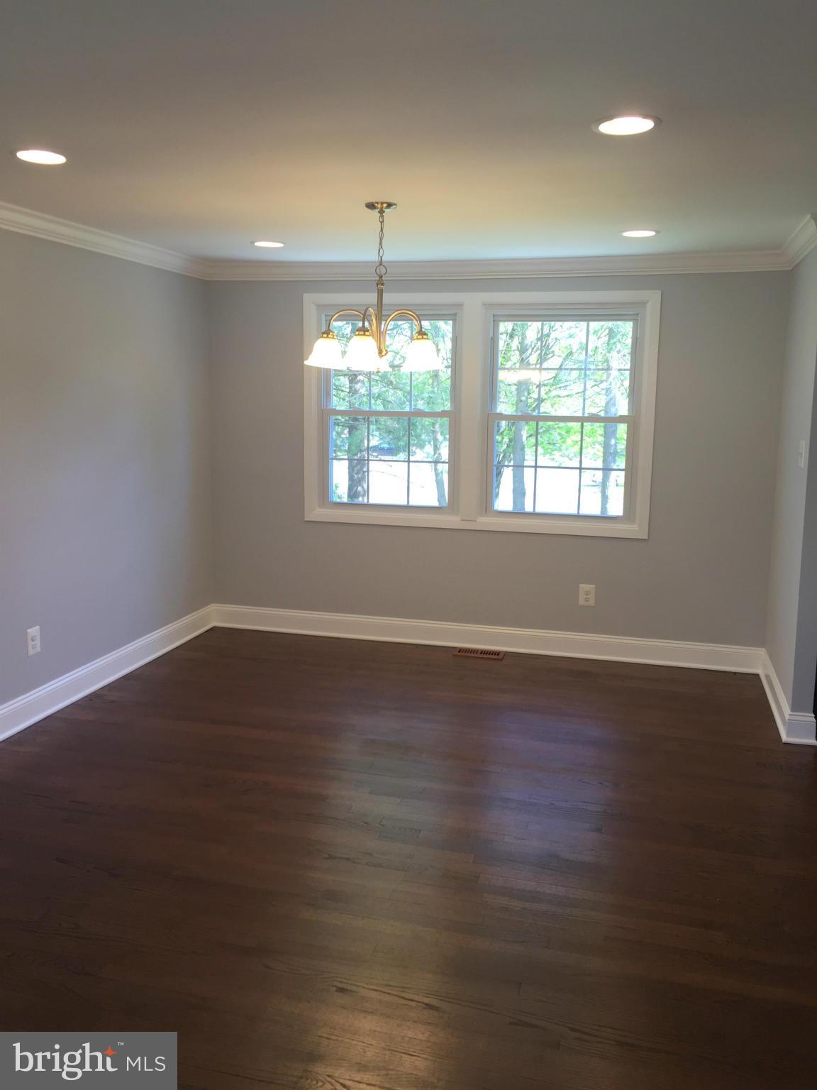 5146 Downwest Ride Columbia, MD 21044 - Photo 5 of 26 an empty room with wooden floor and windows