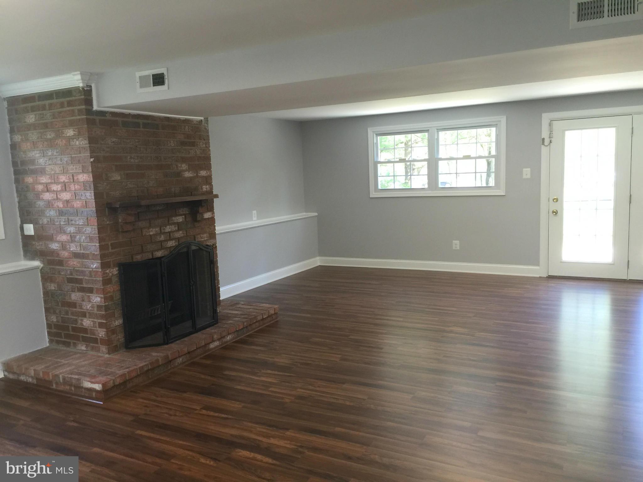 5146 Downwest Ride Columbia, MD 21044 - Photo 9 of 26 a view of empty room with wooden floor and fireplace