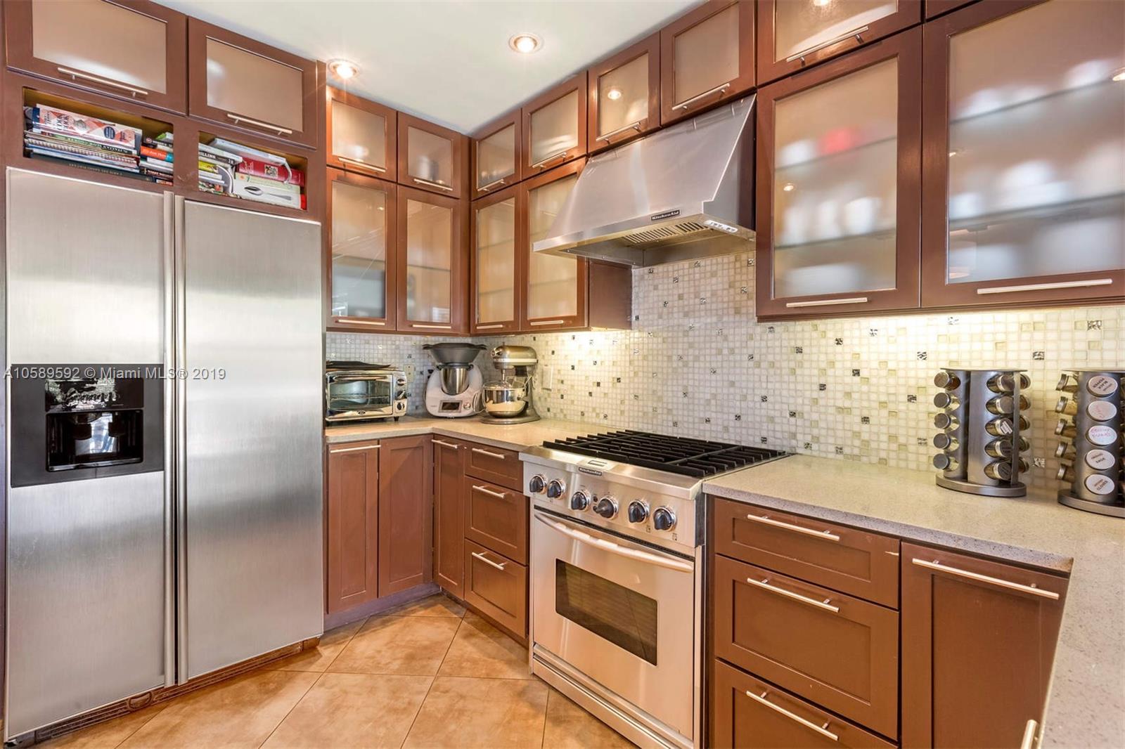 131 Southwest 23rd Road Miami, FL 33129 - Photo 7 of 20 a kitchen with stainless steel appliances granite countertop a stove a refrigerator and a sink