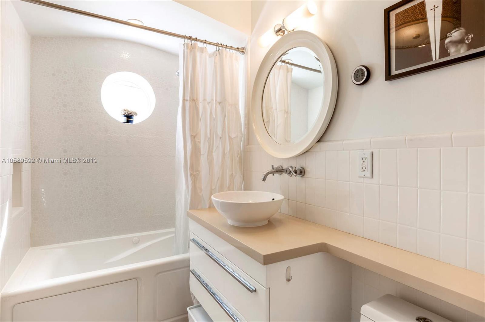131 Southwest 23rd Road Miami, FL 33129 - Photo 10 of 20 a bathroom with a sink and a mirror