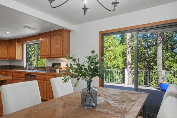 a view of a house with a big yard plants and large trees