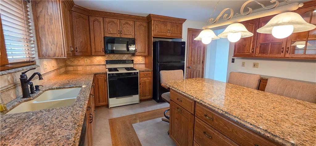 21 Stella Street Burgettstown, PA 15021 - Photo 3 of 20 a kitchen with stainless steel appliances granite countertop a sink and a stove