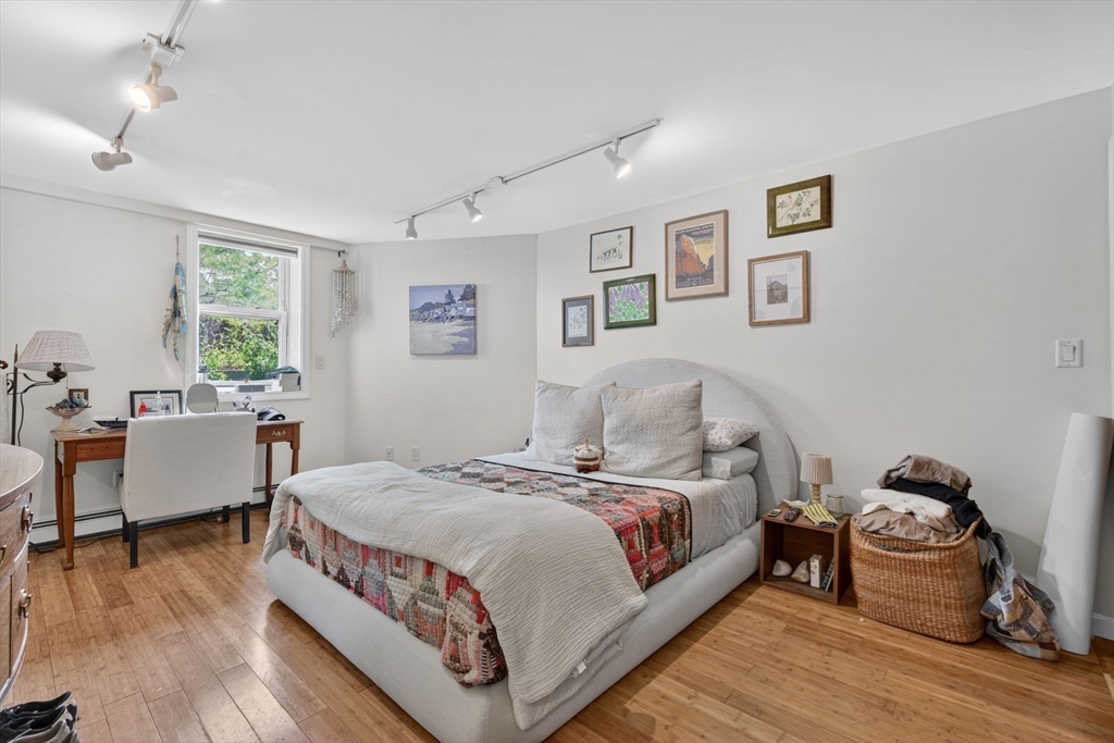 1800 Columbia Road, Unit 6 Boston, MA 02127 - Photo 7 of 11 a bedroom with a bed and wooden floor