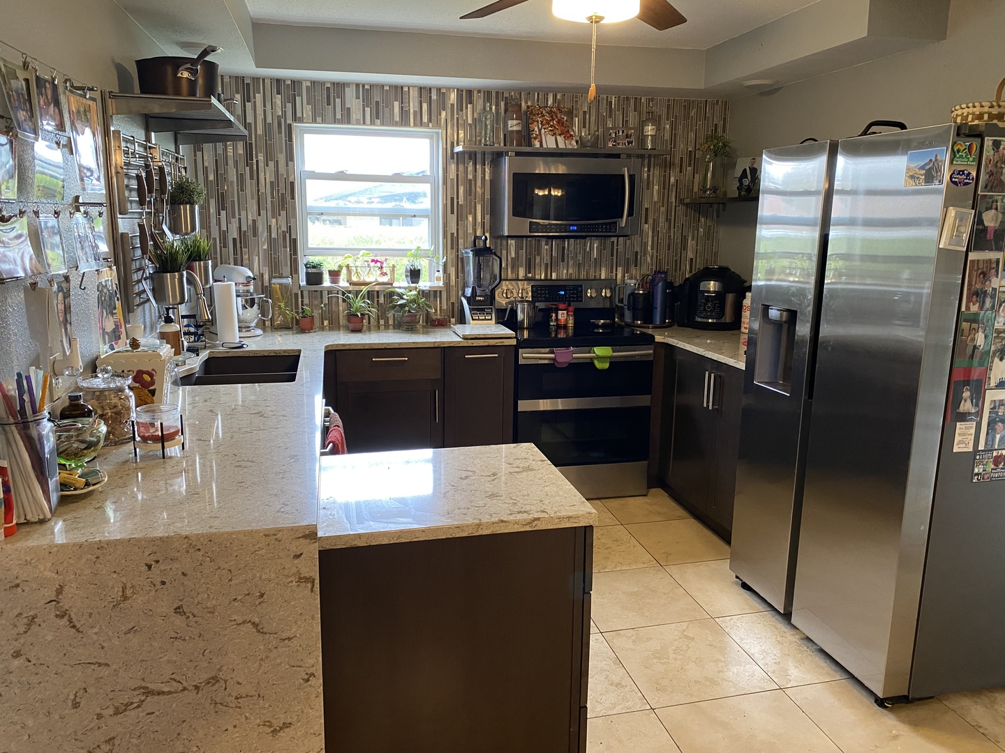 1230 East Calumet Street Centralia, IL 62801 - Photo 5 of 23 a kitchen with stainless steel appliances kitchen island granite countertop a refrigerator a stove top oven a sink and dishwasher