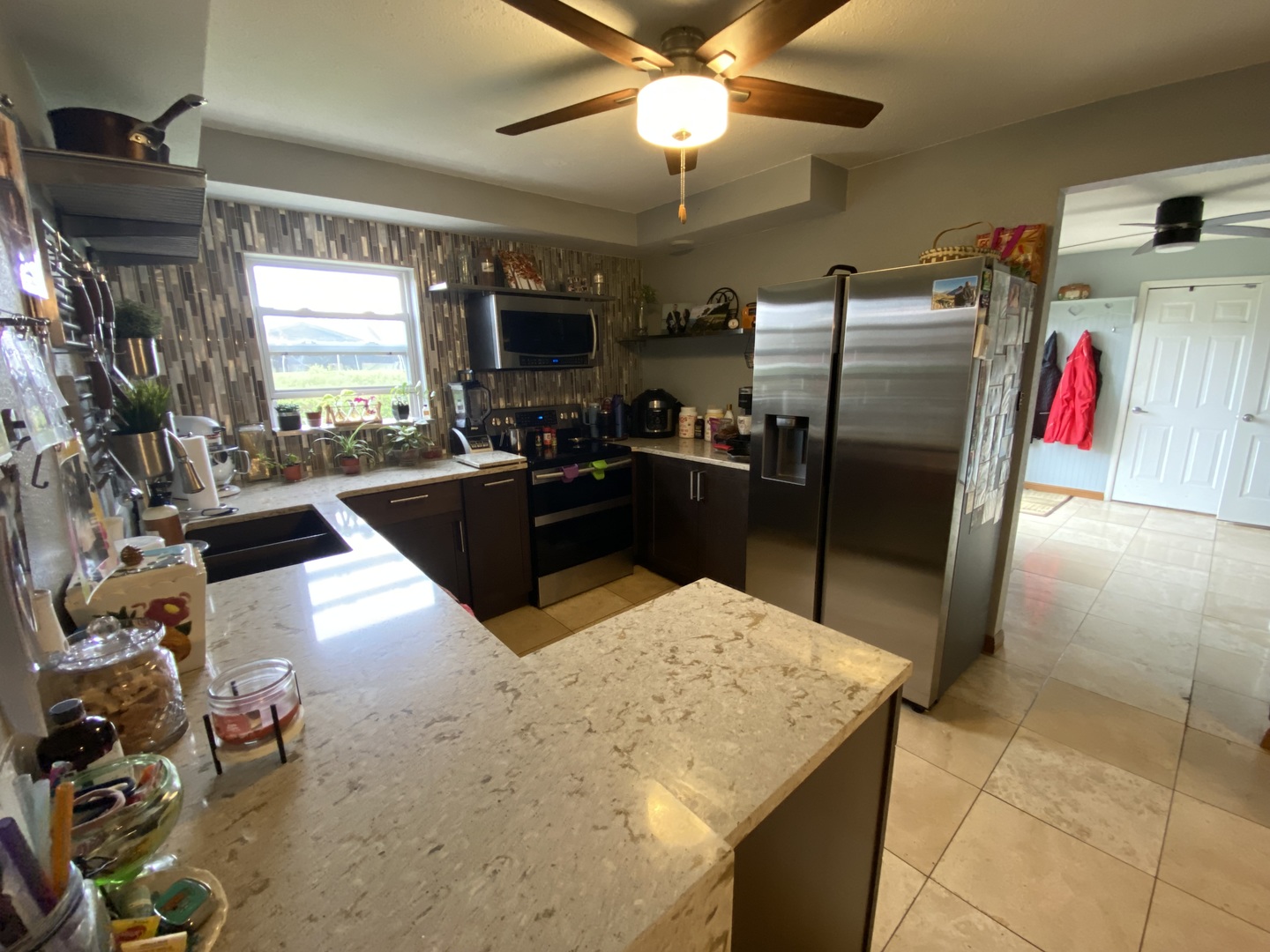 1230 East Calumet Street Centralia, IL 62801 - Photo 6 of 23 a kitchen with stainless steel appliances kitchen island granite countertop a refrigerator a stove and a sink with dishwasher next to a window