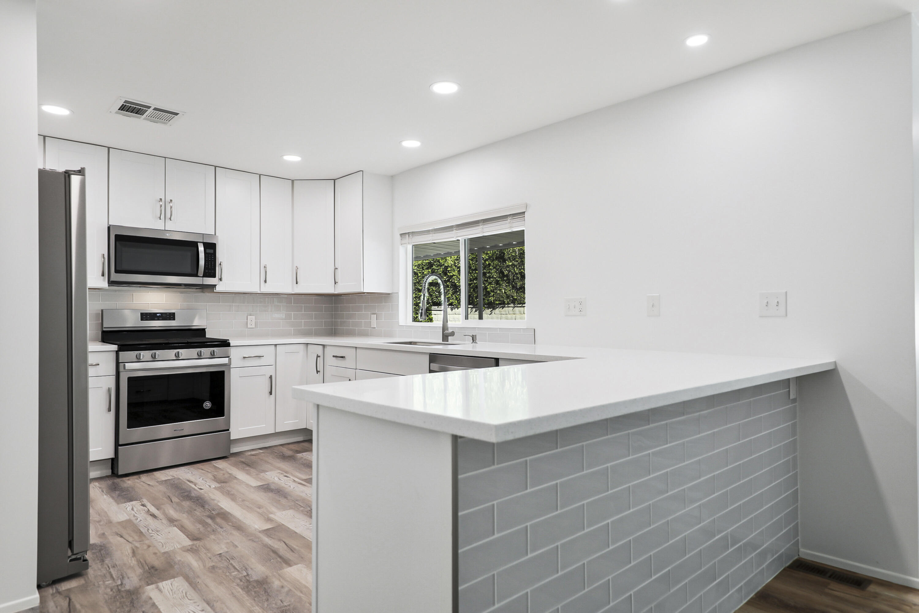 126 Monte Carlo Street Rancho Mirage, CA 92270 - Photo 11 of 33 a kitchen with kitchen island granite countertop a sink stainless steel appliances and white cabinets